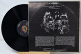 Vinyl record with cover featuring abstract design and text on a light gray background