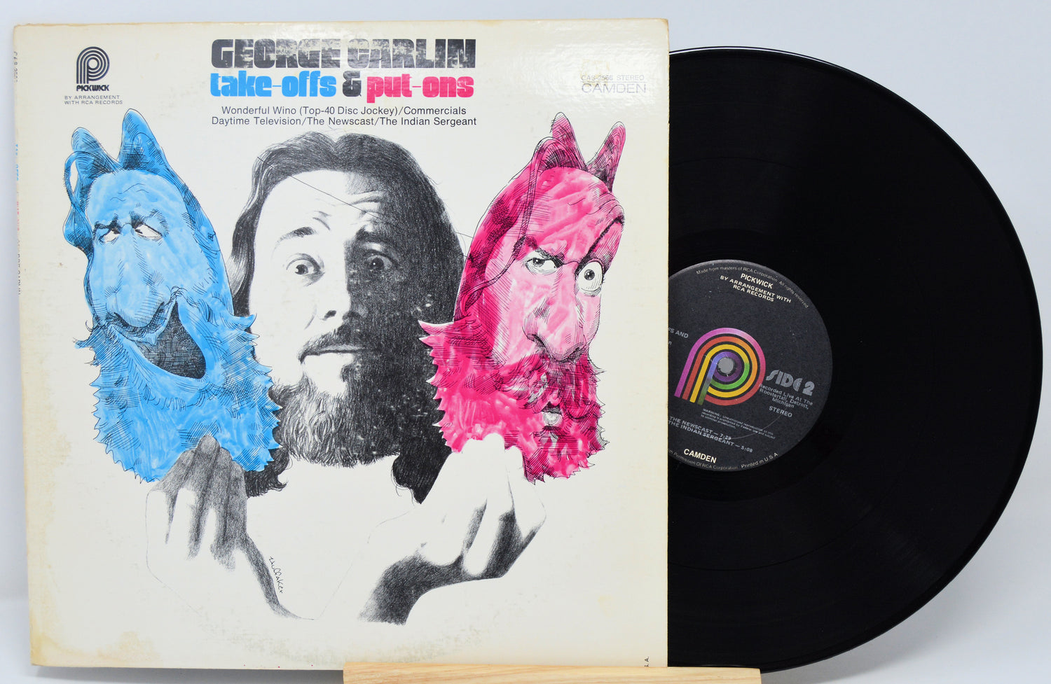 Vinyl record with cover featuring a person and colorful characters on a white background