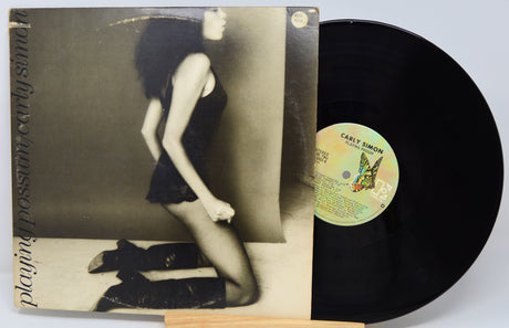 Vinyl record with a cover featuring a woman and a butterfly, on a light gray background.