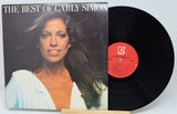 Vinyl record and cover titled 'The Best of Carly Simon' on a light blue background