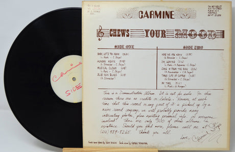 Back cover and vinyl record of Carmine's 'Chews Your Mood' limited demo LP, showing tracklist and handwritten details