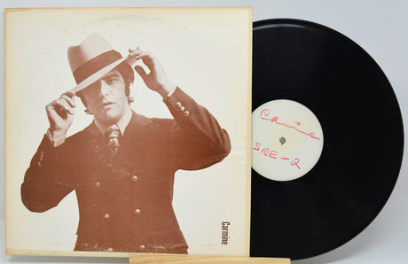 Front cover of Carmine's 'Chews Your Mood' LP featuring Carmine in a suit and hat, with the vinyl partially out