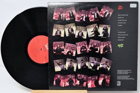 Vinyl record with a colorful cover featuring multiple images of a person.