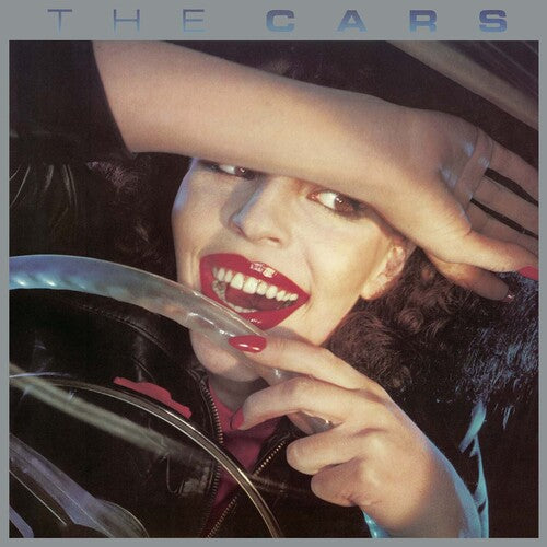 Cars, The - The Cars Album cover of 'The Cars' featuring a person with red lipstick holding a cigarette, leaning towards the camera with a hand on their head, against a car interior background.