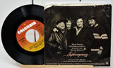 Vinyl record with Columbia label and album cover featuring four men, likely a band, on a white background.