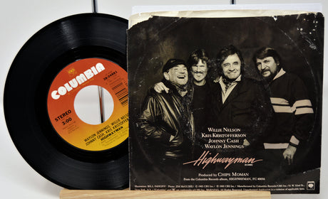 Vinyl record with Columbia label and album cover featuring four men, likely a band, on a white background.