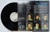Vinyl record with cover featuring images of a family and text.