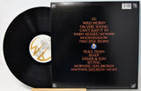Vinyl record with cover displaying album tracklist on a white background