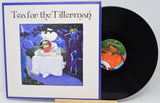 Vinyl record album 'Tea for the Tillerman' with the illustrated cover standing upright next to the black LP on a small wooden display stand.