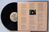 Vinyl record with cover displaying text and a photo of a person.