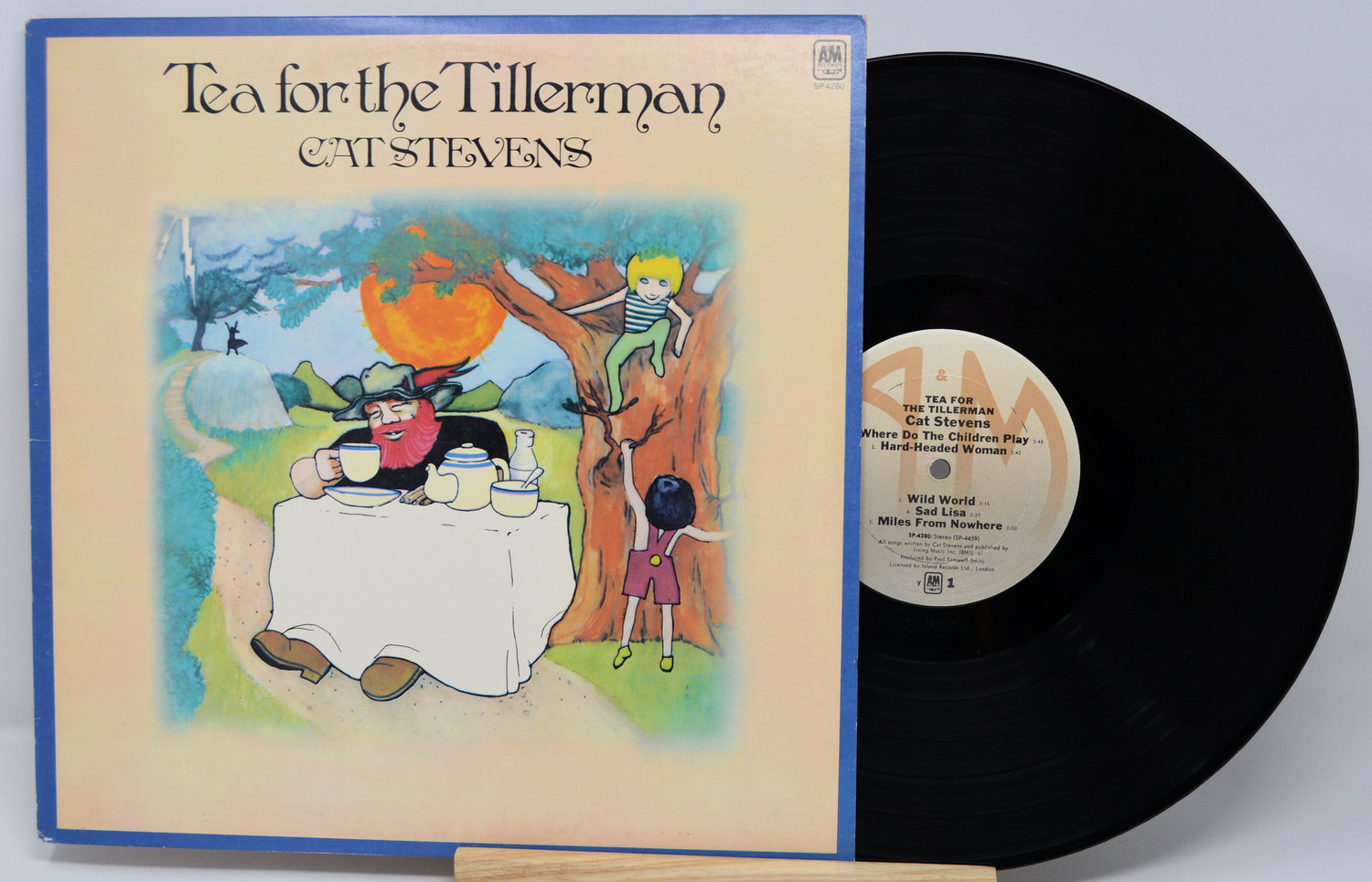 Vinyl record and cover of 'Tea for the Tillerman' by Cat Stevens on a light gray background