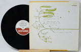 Vinyl record with a guitar headstock design on the cover