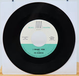 Vinyl record with a white label featuring text and a black border.