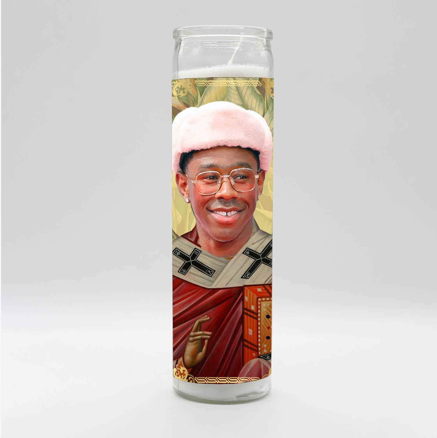 Decorative prayer candle featuring a celebrity portrait in a saintly design with a pink hat