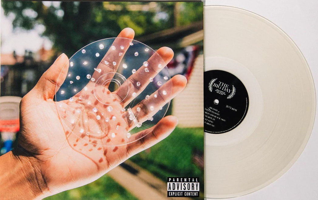 'Chance The Rapper' vinyl record titled 'The Big Day' with a hand holding a clear plastic disc against a blurred outdoor background.