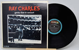 Vinyl record with cover featuring Ray Charles performing on stage.