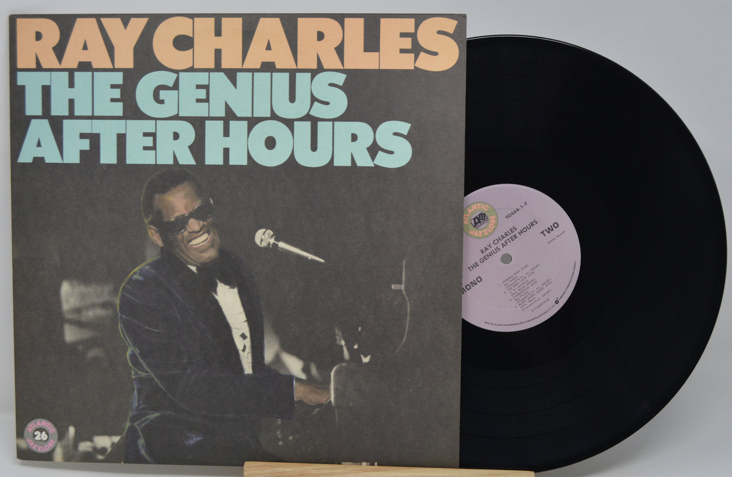 Vinyl record with 'Ray Charles The Genius After Hours' cover showing a musician with sunglasses.