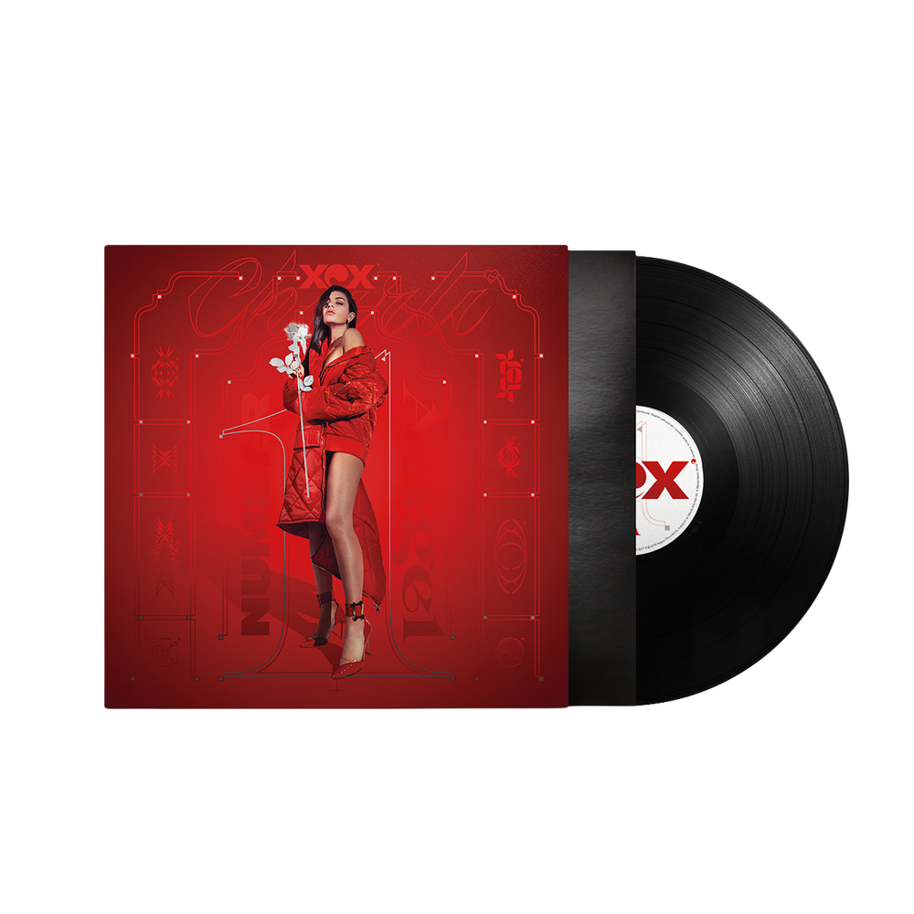 A vinyl record partially pulled from its sleeve, shown on a plain white background. The album cover is predominantly red with a stylized portrait of a woman in a red outfit, and the black record has a red-and-white center label.
