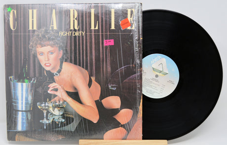 Vinyl record by Charlie titled Fight Dirty with front cover featuring a woman leaning over a bar.