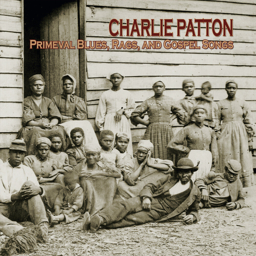 Album cover with black and white photo of people in front of a wooden building, featuring text 'Charlie Patton Primeval Blues, Rags, and Gospel Songs'.