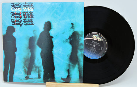 Vinyl record with a blue cover featuring silhouettes of people and the band 'Cheap Trick'.