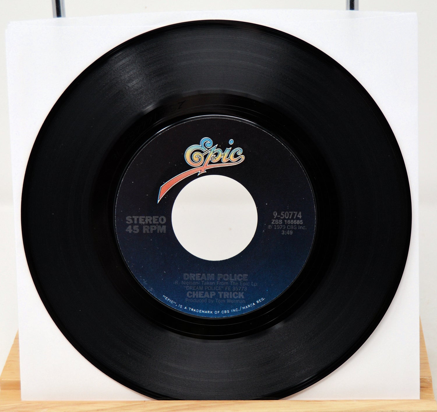 Black vinyl record with 'Opic' label on a white background