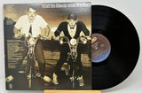 Vinyl record with cover art showing two men on bicycles.