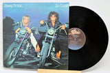 A used vinyl record of Cheap Trick titled 'In Color' with the band members on motorcycles, and the record label visible.