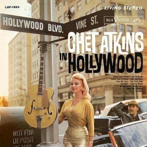 Album cover featuring a woman in a yellow dress standing next to a guitar and Hollywood street sign.