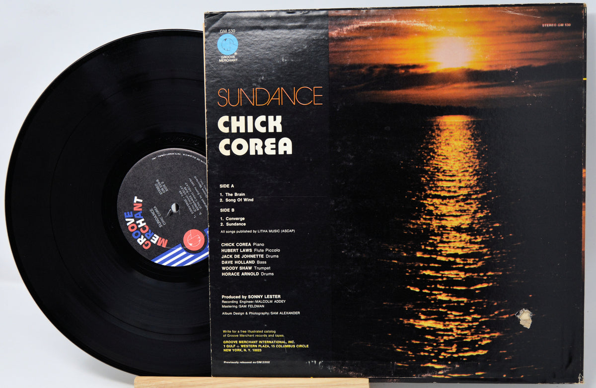 Chick Corea 'Sundance' vinyl record LP with the black record partially pulled from the sleeve, showing the album cover artwork of a sunset over water.