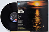 Chick Corea 'Sundance' vinyl record LP with the black record partially pulled from the sleeve, showing the album cover artwork of a sunset over water.