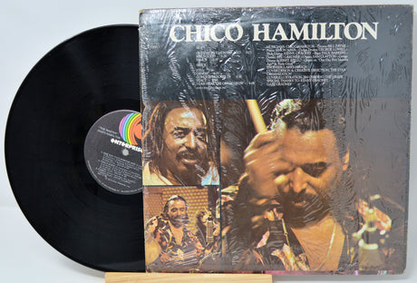 Vinyl record with cover featuring a musician and text 'Chico Hamilton' on a light blue background.