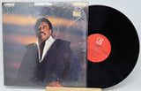 Vinyl record with cover featuring a person, on a white background