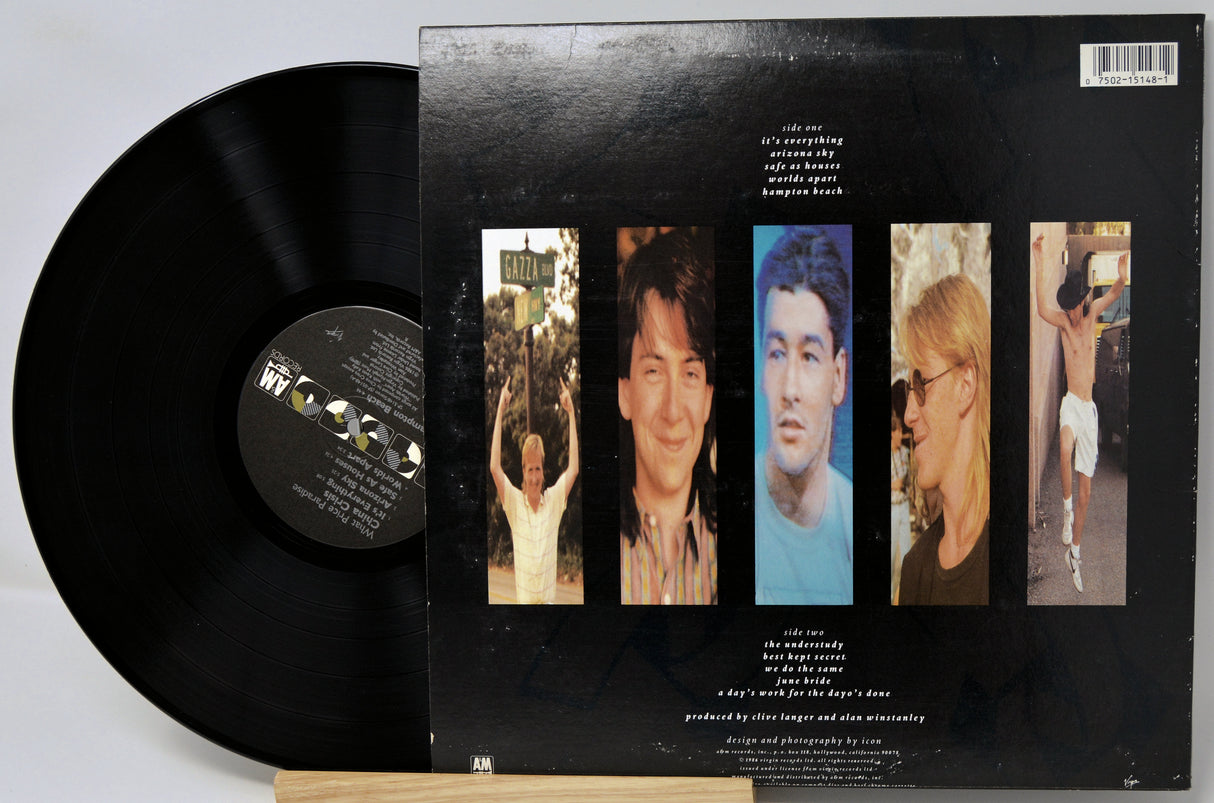 Vinyl record with a black cover featuring images of a person and text on a light gray background