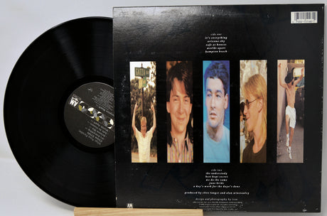 Vinyl record with a black cover featuring images of a person and text on a light gray background
