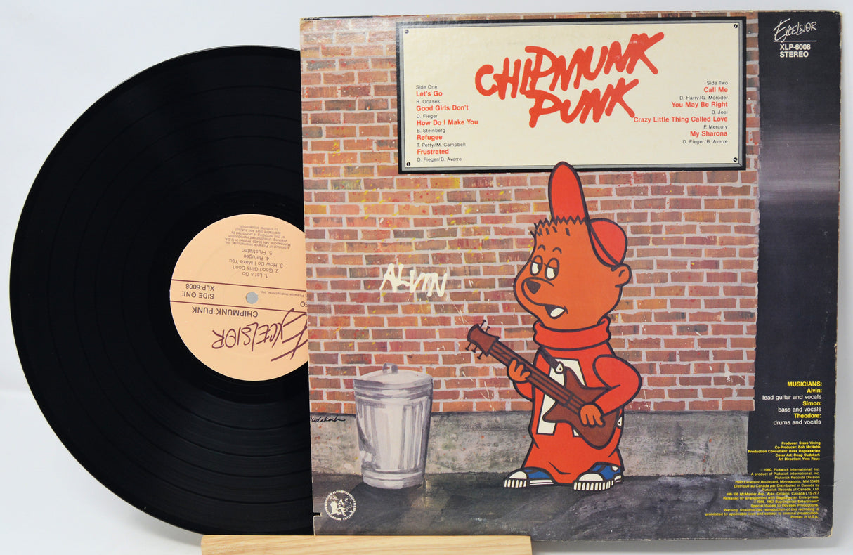 Vinyl record with a colorful cover featuring a cartoon character holding a guitar against a brick wall.