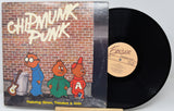 Vinyl record with cartoon characters on the cover against a brick wall background