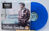 Blue vinyl record with Chris Isaak in plaid shirt and car, featuring Chris Isaak's 'Forever Blue' album.