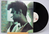 Vinyl record with a cover featuring a person's profile and the name 'Chris Isaak'.