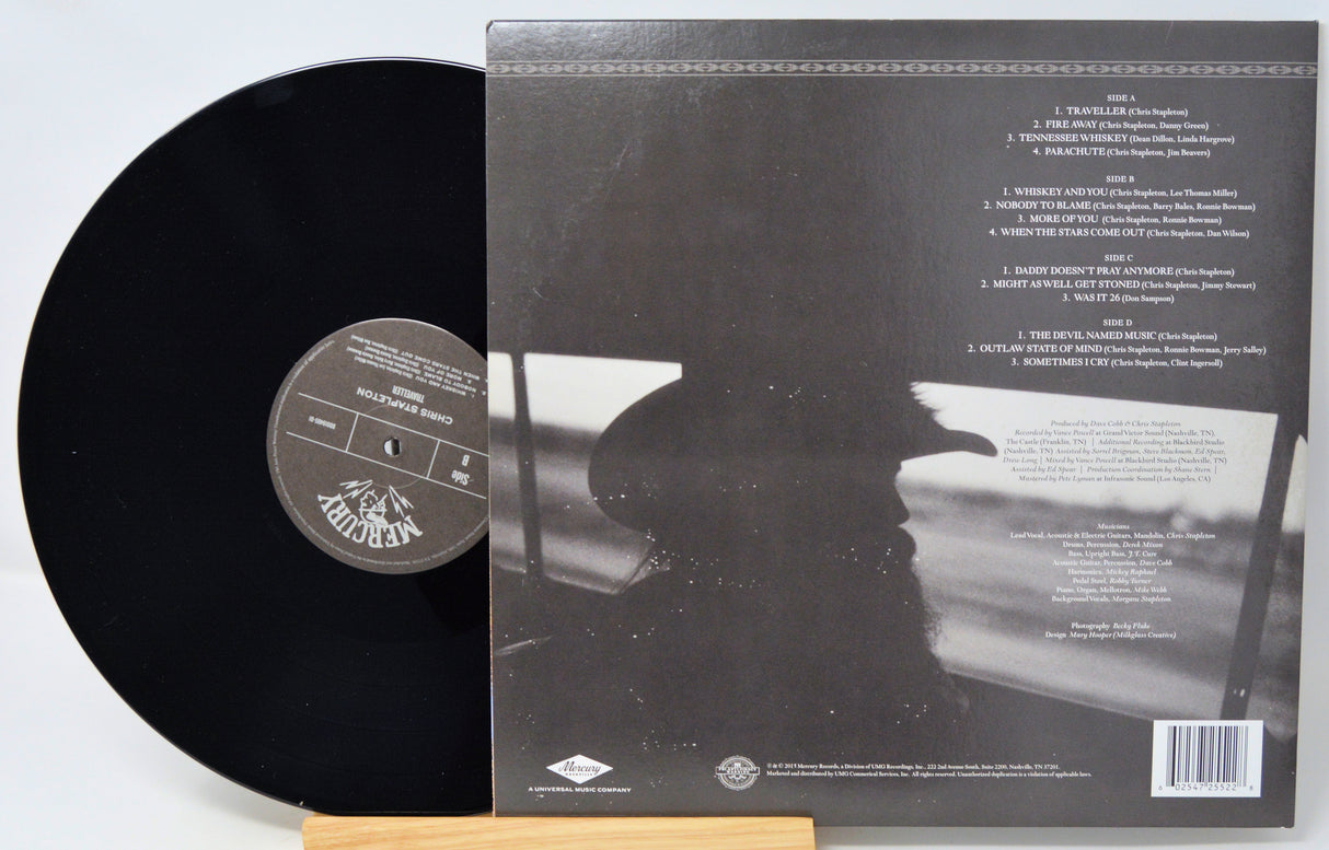 Vinyl record with cover displaying text and a silhouette of a person.