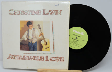 Vinyl record with cover featuring 'Christine Lavin Attainable Love' on a white background