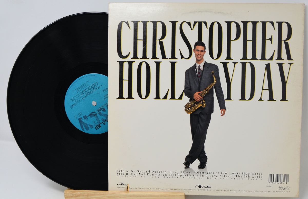 A vinyl record partially pulled from its album cover, featuring Christopher Holaday. The cover has a cream background with bold black text and an illustration of Christopher Holaday in a suit holding a saxophone.