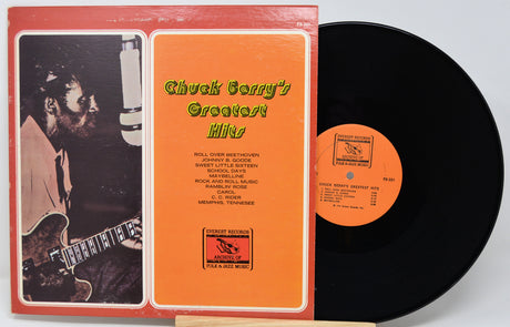 Vinyl record with orange cover featuring Chuck Berry's Greatest Hits and a guitar player.