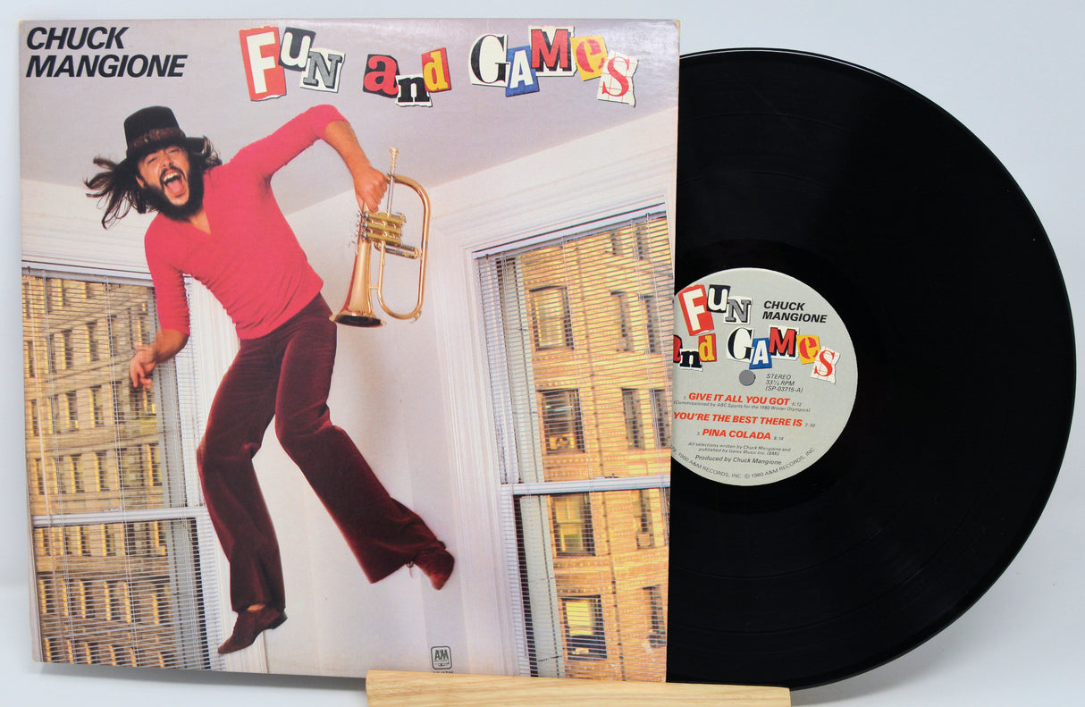 Vinyl record with cover featuring a person playing a trumpet, titled 'Fun and Games' by Chuck Mangione.