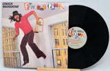 Vinyl record with cover featuring a person playing a trumpet, titled 'Fun and Games' by Chuck Mangione.