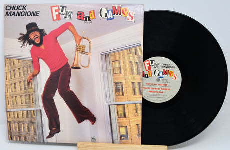 Vinyl record with cover featuring a person playing a trumpet, titled 'Fun and Games' by Chuck Mangione.