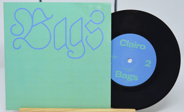 Vinyl record with green cover and blue label on a white background