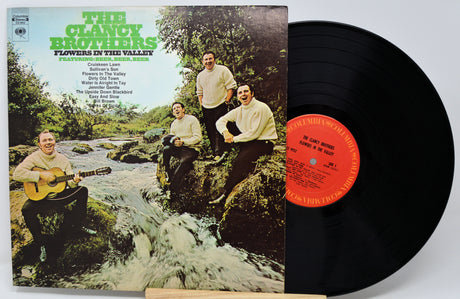 Vinyl record with cover featuring The Clancy Brothers and 'Flowers in the Valley' on a white background