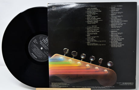 Vinyl record with a colorful guitar headstock design on the cover
