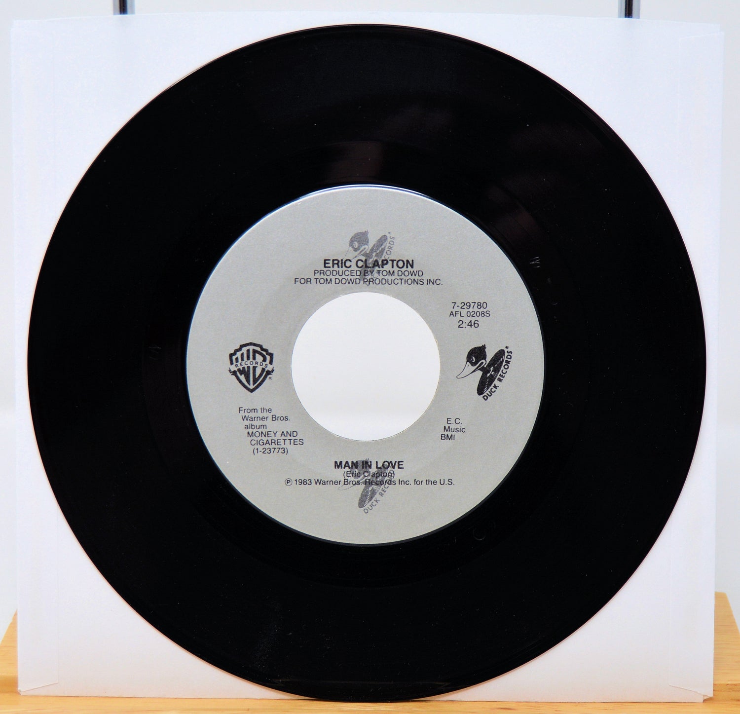 Vinyl record with a white label featuring Eric Clapton's name on a white background